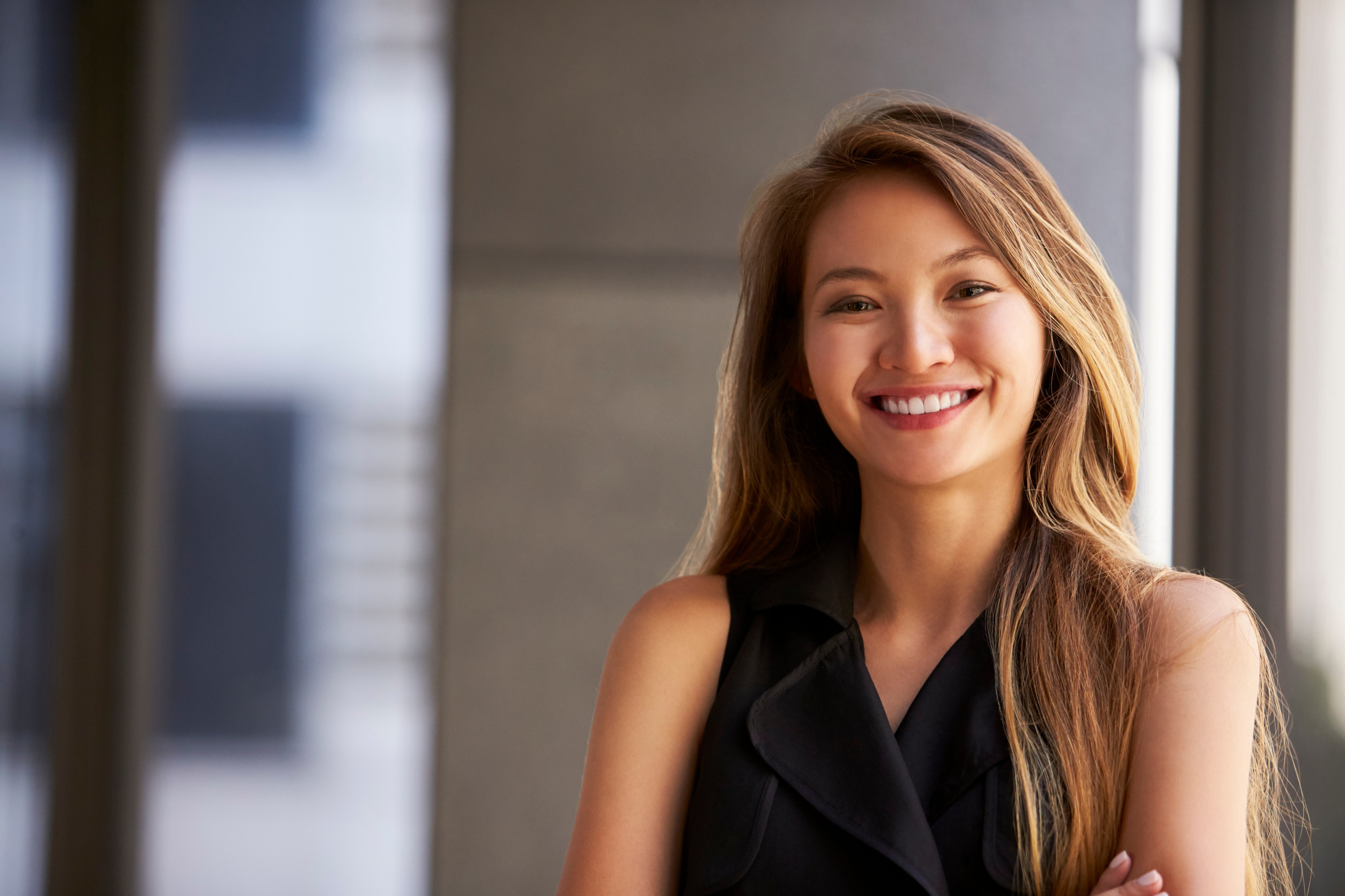 young-asian-businesswoman-smiling-to-camera-close-P76CMQJ